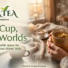 Warm hands holding a steaming cup of tea with Asha Tea logo, blending workspace and home comfort