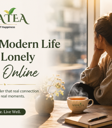 A thoughtful woman who feels lonely online looking out a sunlit window with a warm cup of Asha Tea.